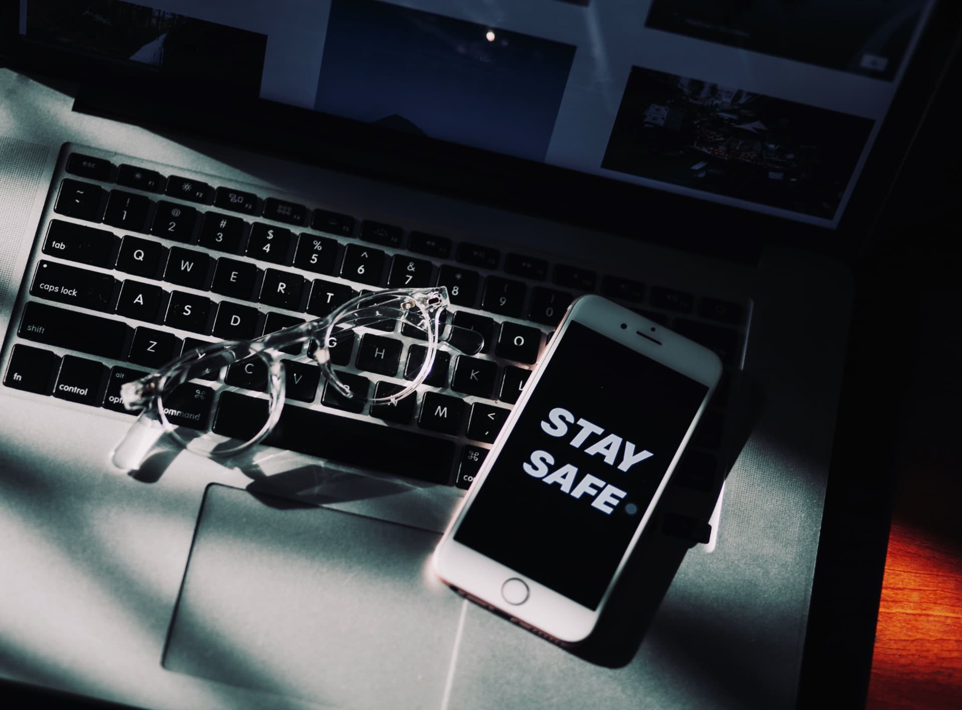 Phone on a laptop showing the words stay safe