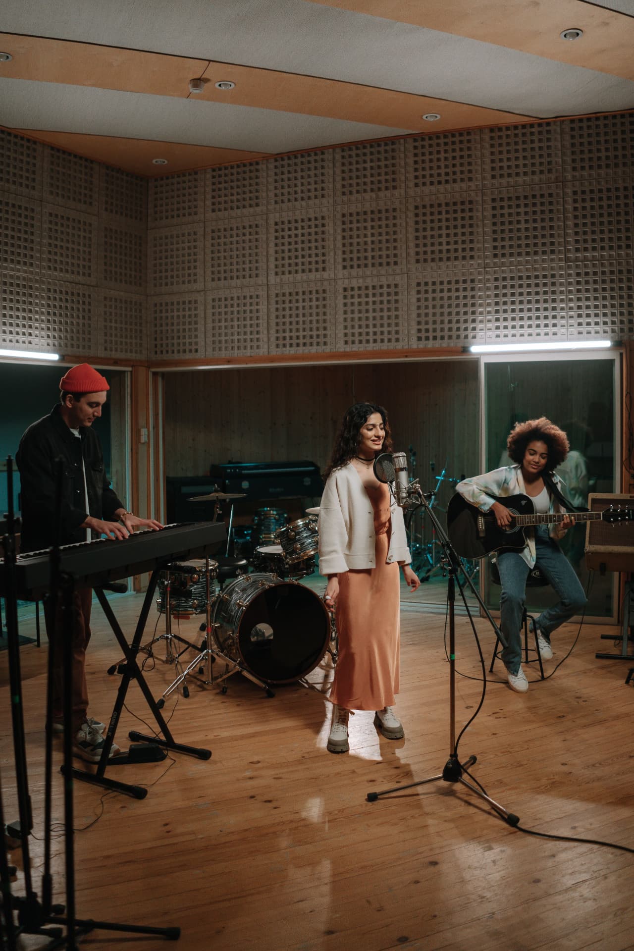 Band recording together in a studio live room